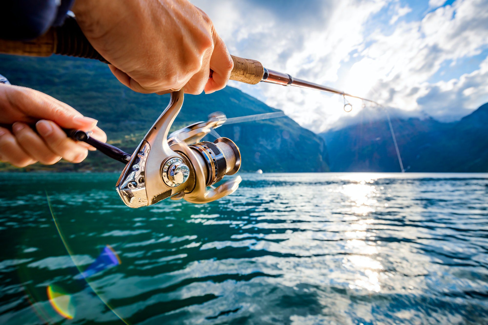 Woman fishing on Fishing rod spinning in Niagara Falls Lake
