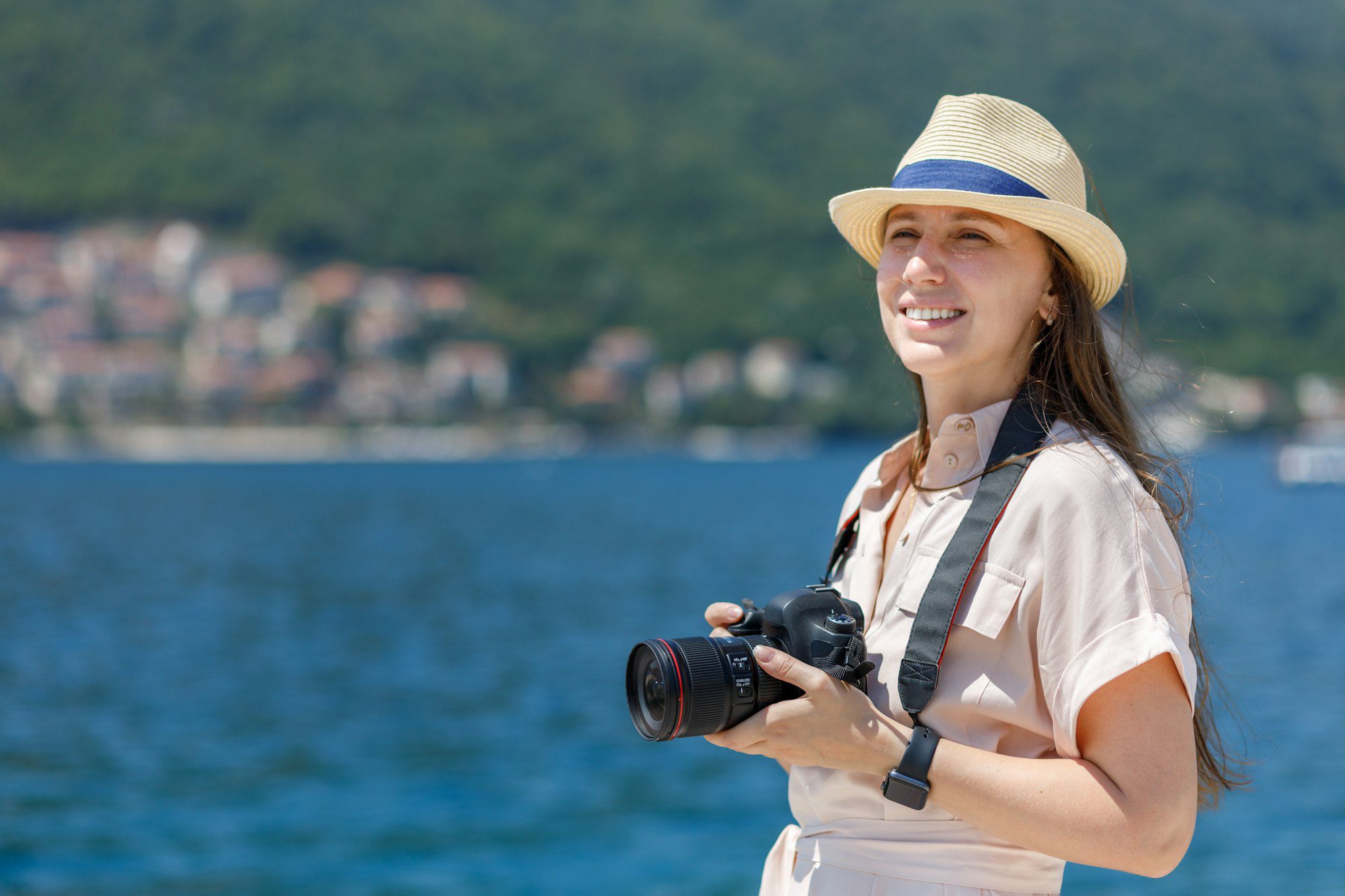 Young woman taking photo on camera on her vacation trip in Adriatic